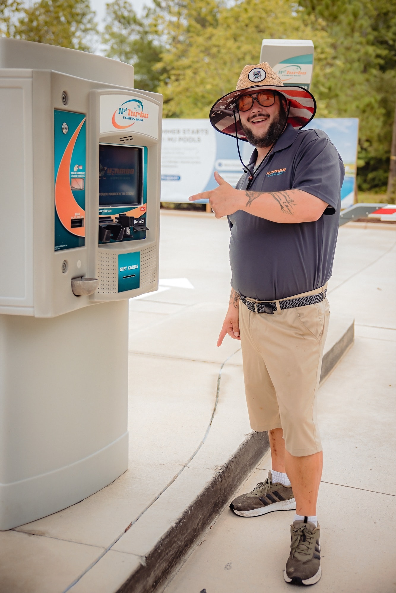 An H2Turbo attendant showing the way to the pay kiosk